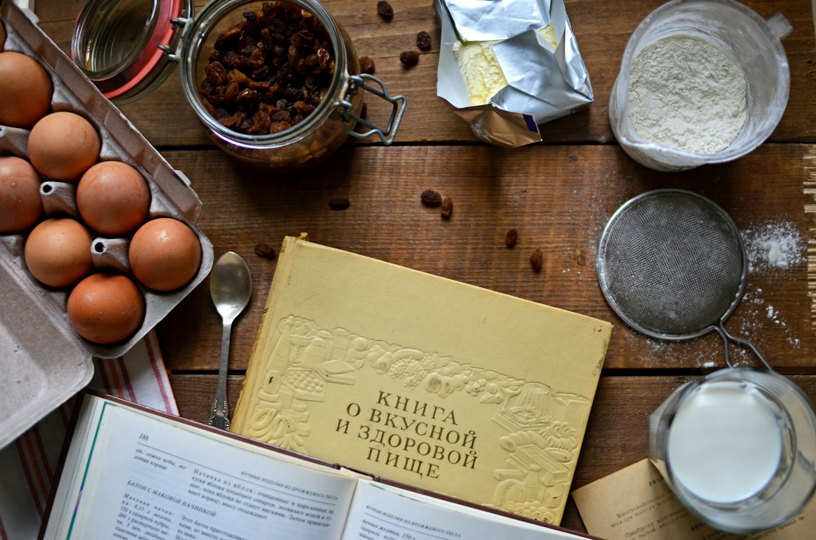 Open notebook, pen and recipe pages spread out for planning a menu
